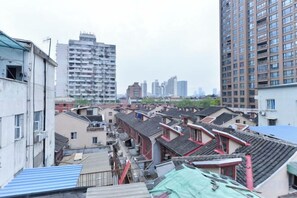 A residential area with traditional architecture, including buildings with tiled roofs and a mix of residential and commercial structures. - Red House Hotel (Shanghai Red House Hospital Lujiabang Road Subway Station Branch) (Shanghai)