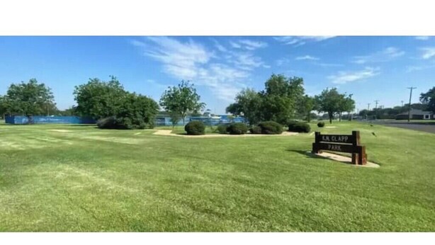 A sign for E.J. Glapp Park with a grassy area and trees in the background. - Affordable + Pet Friendly 1 BR + sofa bed/1BA #B (Lubbock)