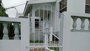 A gated entrance with a staircase leading to a building. - Charming One-Bedroom Apartment in Peaceful Telescope, St. Andrews, Grenada (Telescope)