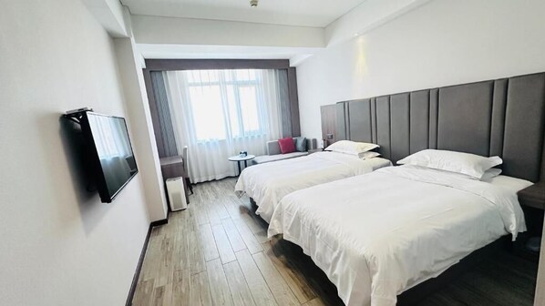 A hotel room with two beds, a flat-screen TV, a small table, and a window with curtains. - Bestway Hotel - Grand Tang Dynasty (Xi'an)