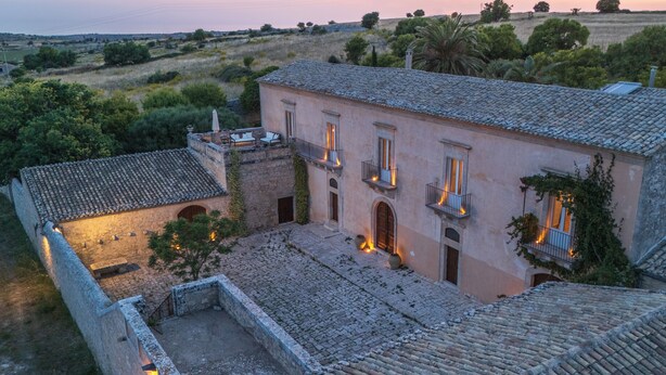 A historic building with a courtyard, stone walls, and a tiled roof. - Scifazzo, ancient Sicilian villa with pool (Ragusa)