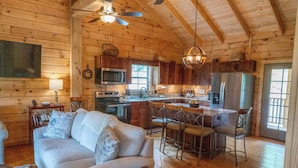 A cozy cabin interior with a living room, kitchen, and dining area. - Pinhoti Ridge Retreat Cabin 1, Pinhoti Path (Talladega)