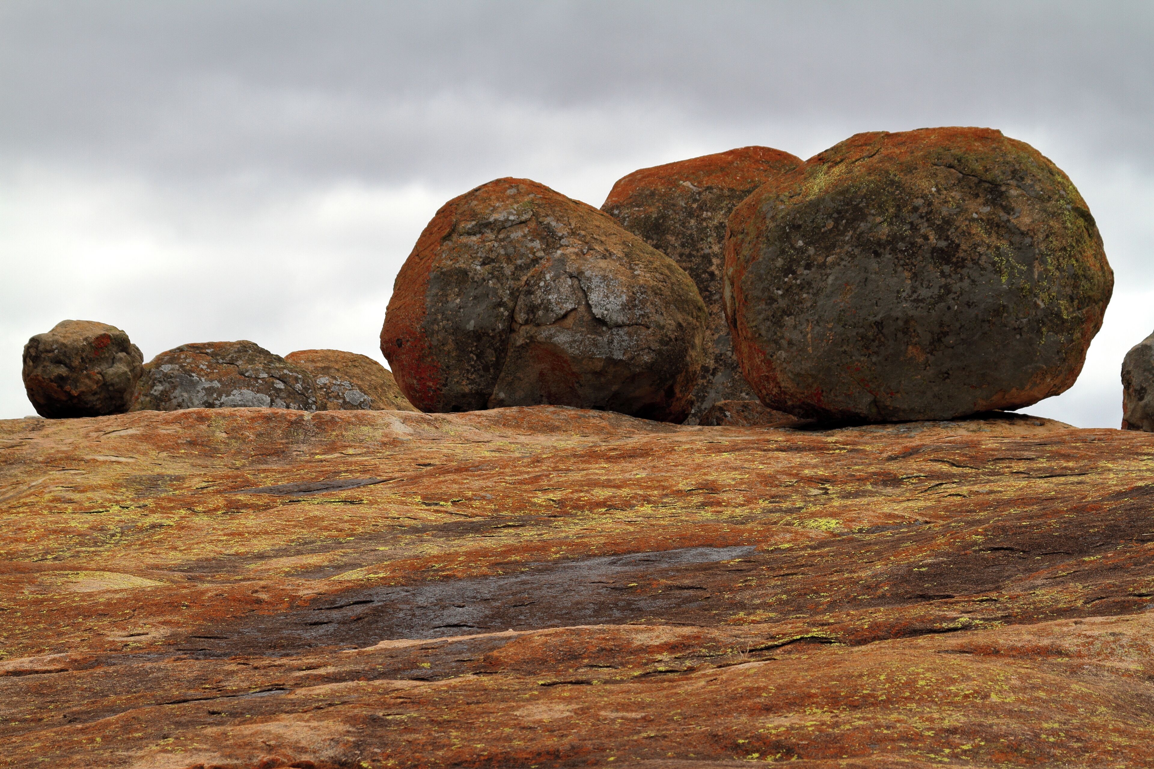 A large rock formation with several rounded boulders.