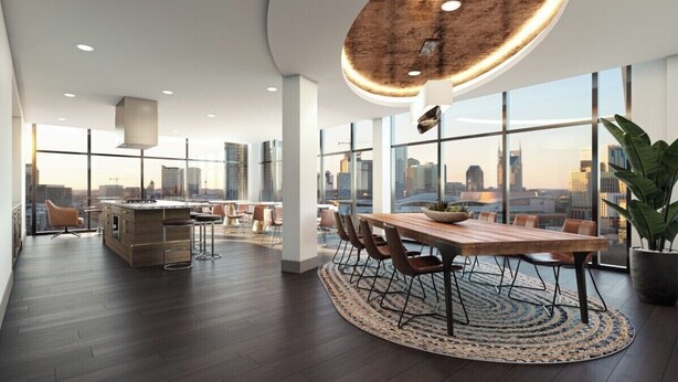 A modern kitchen with a central island, large windows, and a city view.
