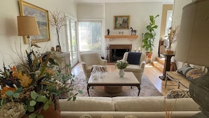 A living room with a sofa, chairs, a coffee table, and a fireplace. - Gorgeous Solana Beach 3 bd pool, view, perfect for beach & racetrack  (Solana Beach)