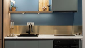 A modern kitchen with a built-in oven, a sink, and pendant lighting. - Trendy & Private City Studios Near Cismigiu & Calea Victoriei (Bucharest)