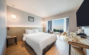 A hotel room with a bed, bedside table, lamp, and a view of the outdoors. - Incheon The Rest Hotel (Incheon)