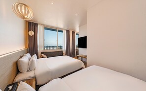 A hotel room with two beds, a television, a desk, and a balcony with curtains. - Incheon The Rest Hotel (Incheon)
