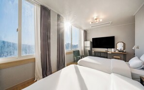 A hotel room with two beds, a TV, a desk with a chair, and a view of the outdoors. - Incheon The Rest Hotel (Incheon)