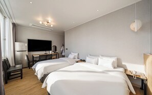 A hotel room with two beds, a desk, a flat-screen TV, a mirror, a lamp, and a telephone. - Incheon The Rest Hotel (Incheon)