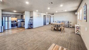 A spacious living area with a kitchen, dining table, and seating. - Angler Hideaway | Belle Starr Marina | Pool | Fish (Checotah)