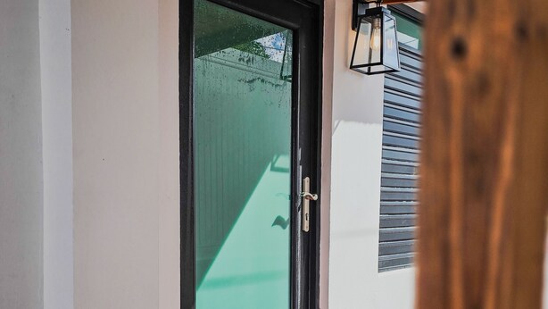 A door with a glass panel, a wooden ceiling, and orange-tiled flooring. - Private Colonial w/ Modern twist 2 BR w/Pkng & Laundry (Carolina)