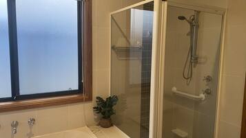 Shower, hair dryer, towels, toilet paper
