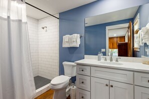 A modern bathroom with a shower, toilet, and sink. - Charming 2BR home in Saint Marys Historic Downtown: Dining, Shops, Ferry Steps Away (Saint Marys)