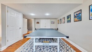 Enjoy a game of ping pong on the patterned rug in this stylish room.