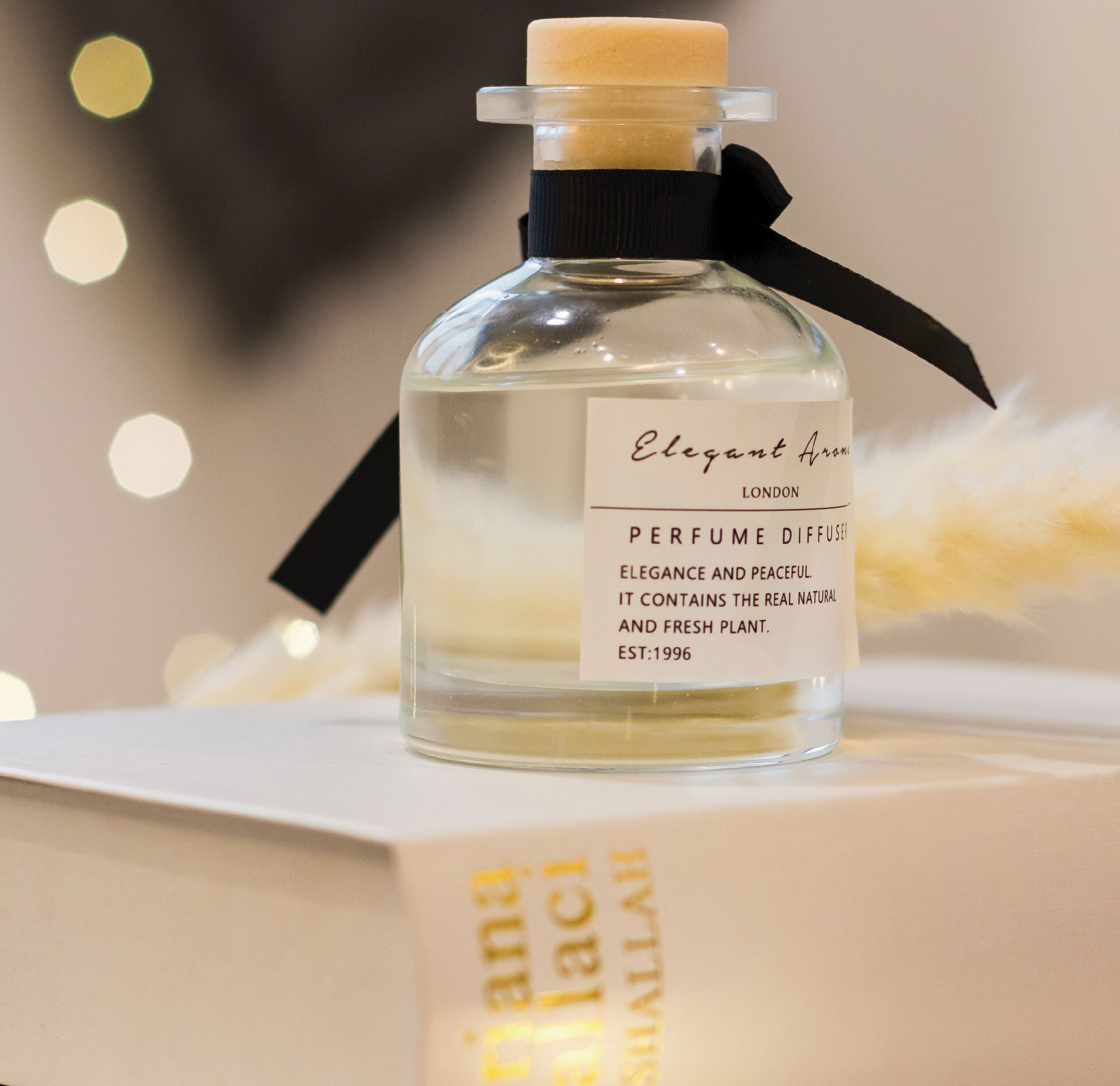 A perfume bottle with a label that reads "Elegant Aroma London Perfume Diffuser" and "Est. 1996".