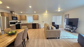 A modern apartment with a kitchen, dining area, and living room. - Eastern Desert Chic (Umatilla)