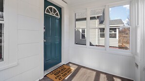 A front door with a doormat, a window, and a view of a house. - NordEast Escape/Hot Tub, Bocce court, Fooseball, Patio, Awesome location (Minneapolis)