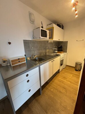 Fridge, microwave, coffee/tea maker, cookware/dishes/utensils