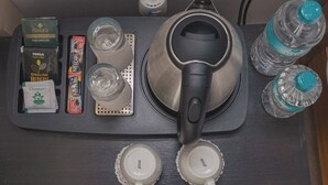 A tray with a kettle, two cups, and various tea and coffee products. - Cozy Home (Pokhara)