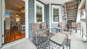 A porch with four chairs and a table, wooden flooring inside, and a ceiling fan. - 2nd Floor 2BR/1BA Getaway – Short Walk to Beach & Boardwalk! (Ocean City)