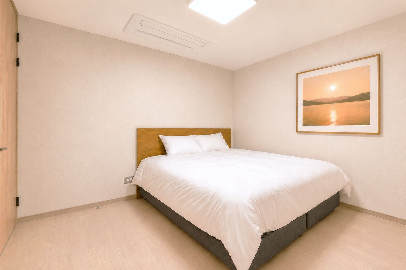 A bedroom with a single bed, a wooden headboard, a wall-mounted picture, and a light switch on the wall.