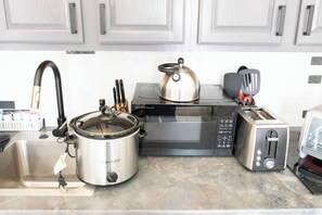 Fridge, microwave, stovetop, coffee/tea maker