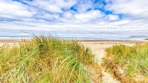 A beach with sand dunes and a clear sky.