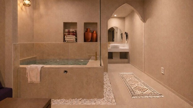 A modern bathroom with a freestanding bathtub, a vanity with a mirror, and a decorative rug. - Stay Passport Morocco Spa Incheon Songdo (Incheon)