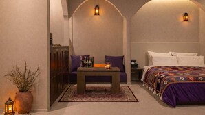 A room with a bed, a sofa, a table, and two wall-mounted lights. - Stay Passport Morocco Spa Incheon Songdo (Incheon)