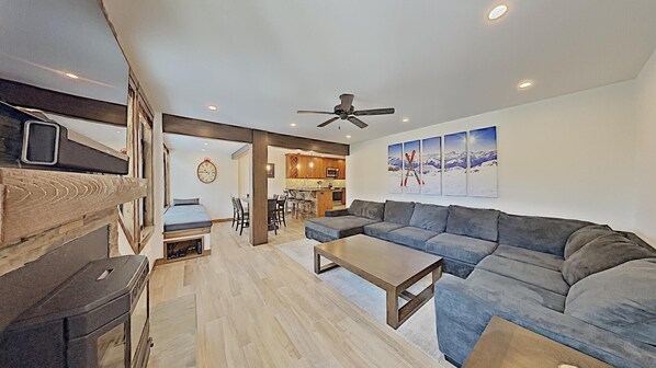 A compact living space with a sofa, a dining table, and a kitchenette.