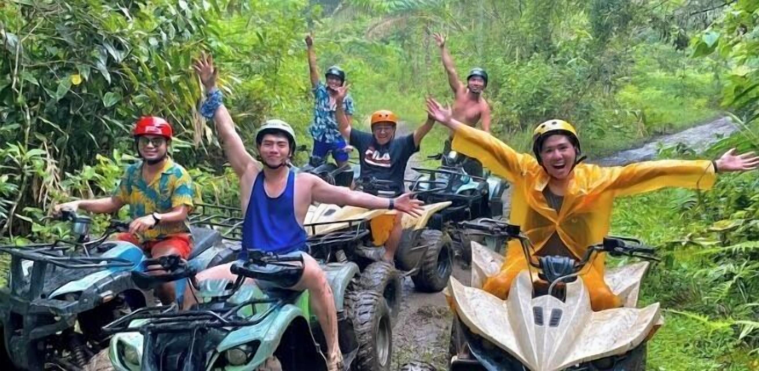 A group of people on ATVs in a lush, green outdoor setting.