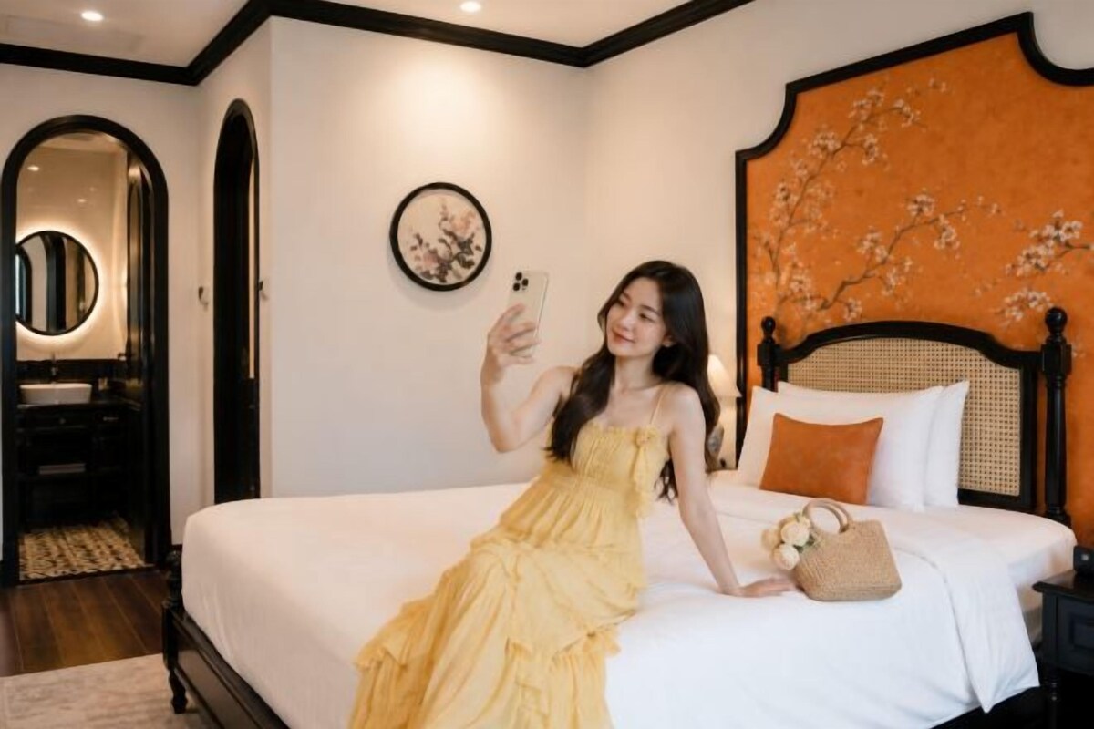 A bed with a headboard, a bedside table, and a wall-mounted picture.