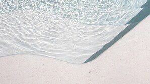 A clear pool with visible ripples on the water surface and a sandy bottom. - the macan Bingin (Pecatu)