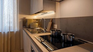 A modern kitchen with stainless steel appliances, a built-in oven, and a sink.