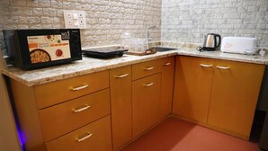 A kitchen with a microwave, toaster, and coffee maker on the counter.