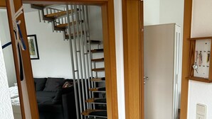 A hallway with a staircase leading to a living area. - Vacation cottage Ditzum (Ditzum)