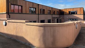 A modern building with a flat roof, large windows, and a concrete base. - Newcastle House Hotel (Ballymahon)