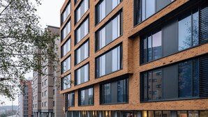 A multi-story building with large windows and a brick facade.
