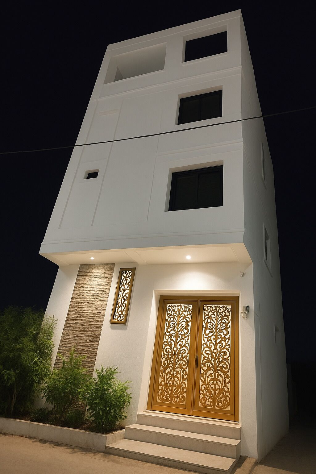 A modern two-story building with a flat roof, a small balcony on the upper floor, and a set of stairs leading to a wooden door with intricate carvings.