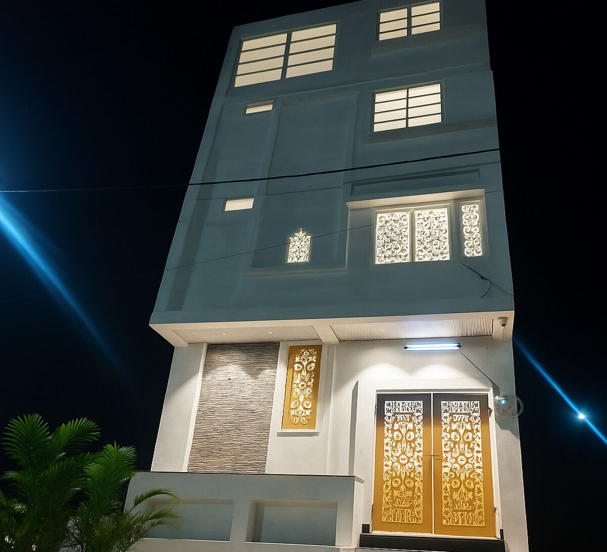 Um edifício de vários andares com janelas iluminadas e painéis decorativos.