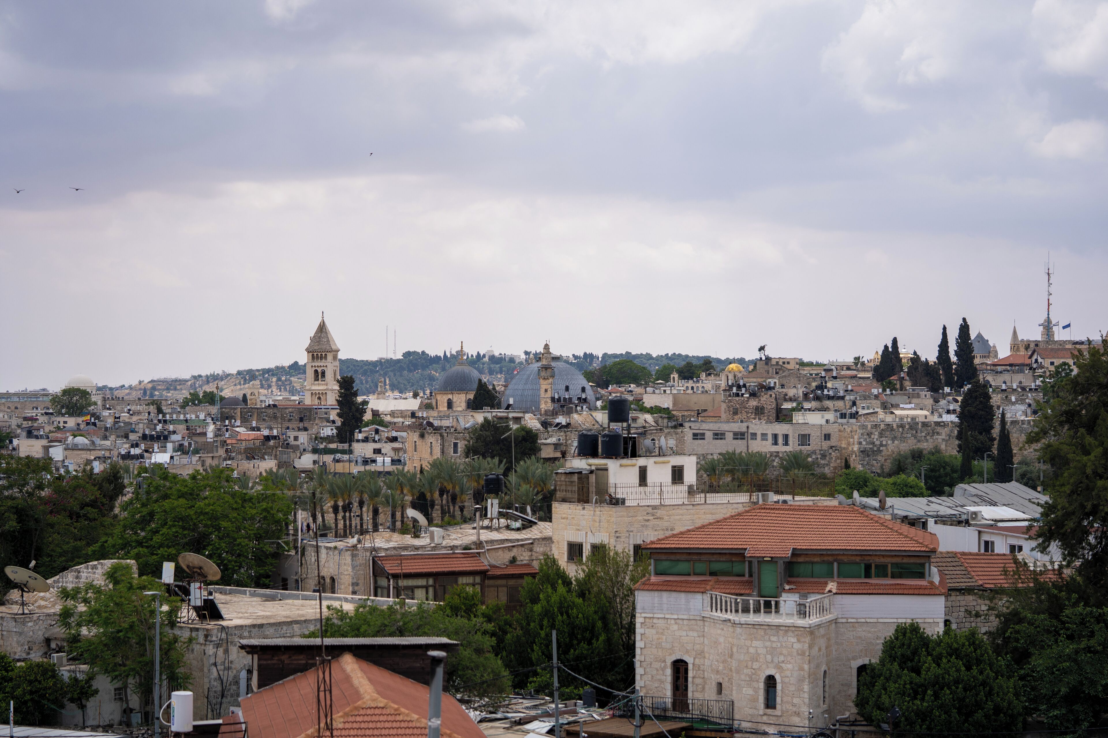 A cityscape with historic buildings, including a prominent tower and dome structures.