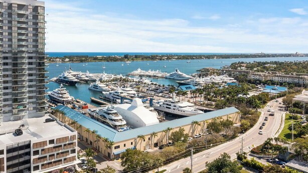 A marina with multiple yachts docked, a large building with a dome, and a road leading to the marina. - Heated Pool Grill Fire Pit & Cold Plunge Sleeps 8! (West Palm Beach)