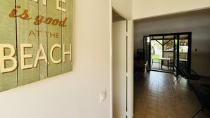 A hallway with a wooden wall sign that reads "Life is good at the beach." - - Casa Anna - beachfront (Borgo)
