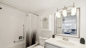 A modern bathroom with a bathtub, toilet, and sink. - Legacy at Imperial Village 516 I 2 Bed 2 Bath (Ric hmond)