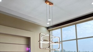 A modern room with a large window, a ceiling light fixture, and a wall-mounted light. - GoBravo 11 6BHK Farm with Pool Sohna Road Gurgaon  (Sohna)