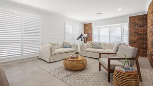 A modern living room with two sofas, a coffee table, and a lamp. - SCOTTS RETREAT - RELAX BY THE POOL (Scotts Head)