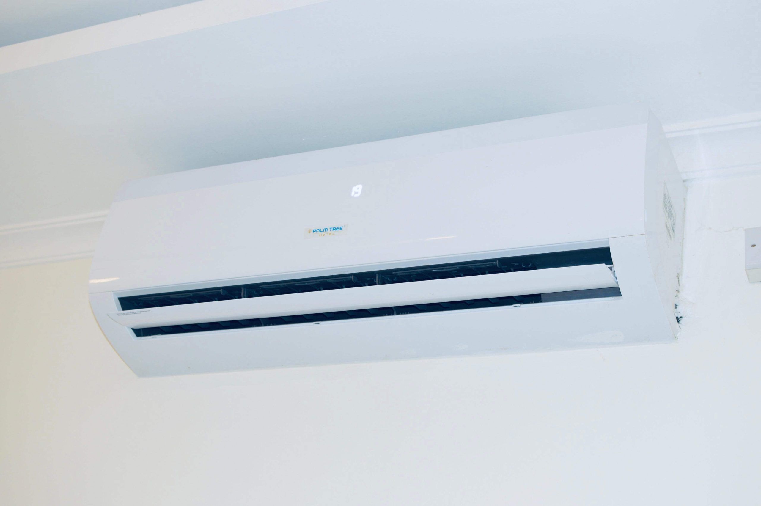 A white air conditioning unit mounted on a wall.