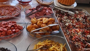 A buffet spread with various food items including pasta, meats, and desserts. - Aydın Motel (Marmara)