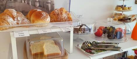 A bakery display with various pastries and a sandwich board.